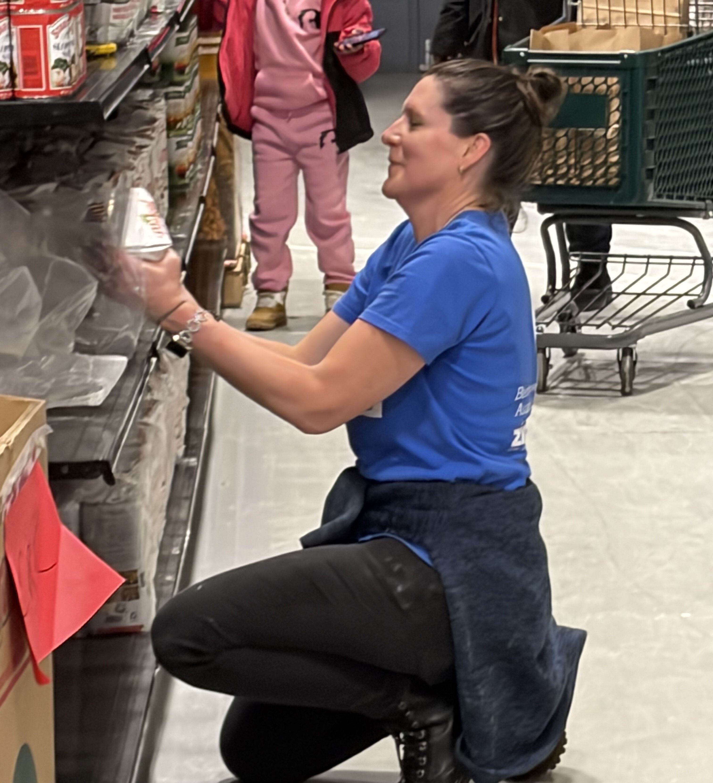Zinner and Co. Employee Stocking The Shelves At The Greater Cleveland Foodbank